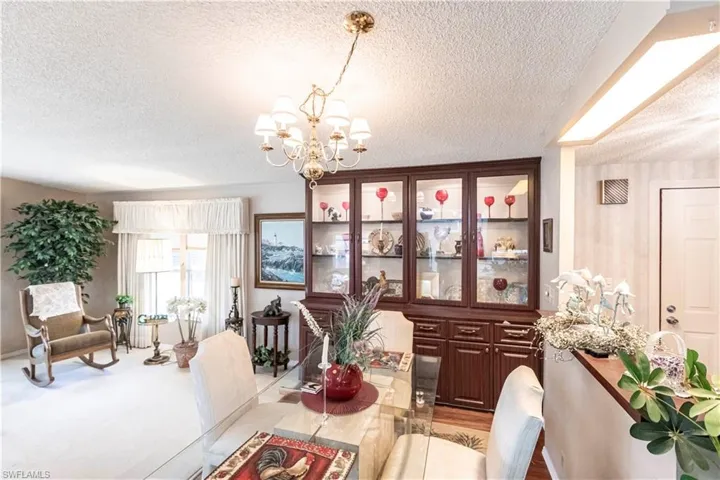 Dining area featuring a textured ceiling and a chandelier