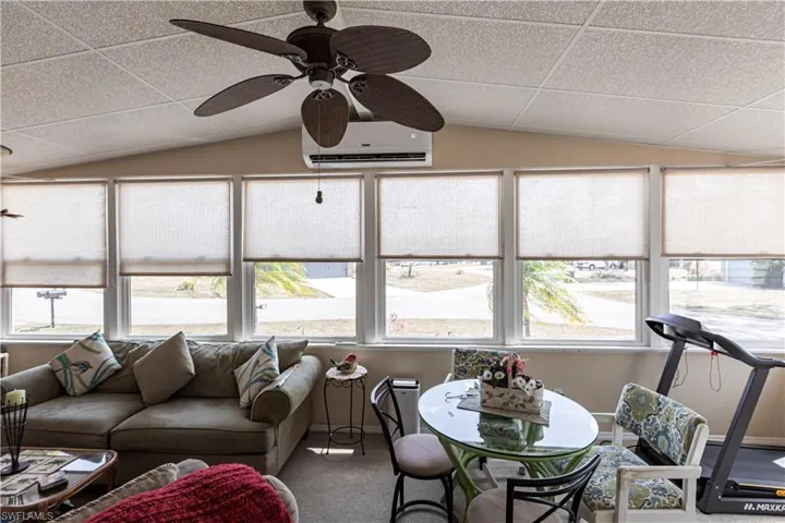 Sunroom / solarium with plenty of natural light and an AC wall unit