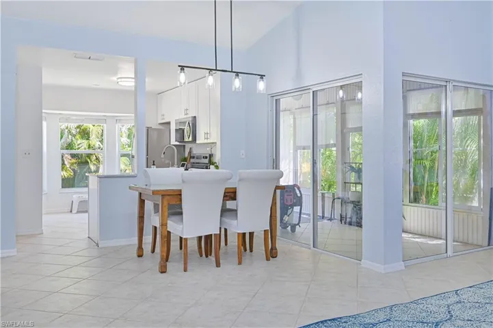 Dining area with light tile patterned flooring, baseboards, and visible vents