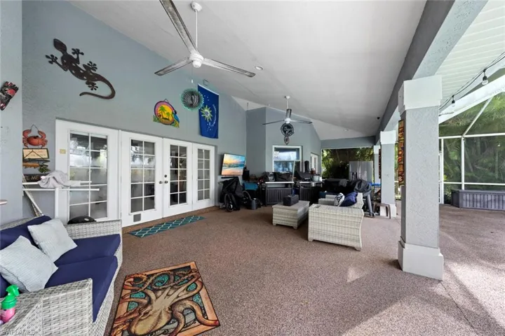 View of patio / terrace featuring glass enclosure, ceiling fan, outdoor lounge area, and french doors