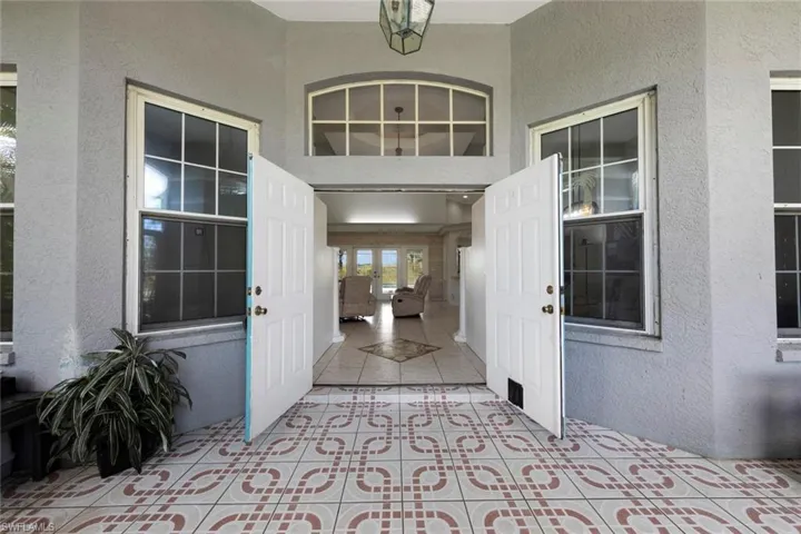 Doorway to property featuring a patio area