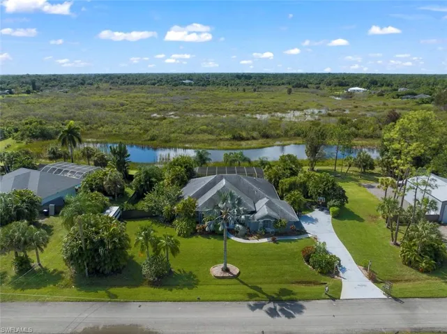 Birds eye view of property with a water view