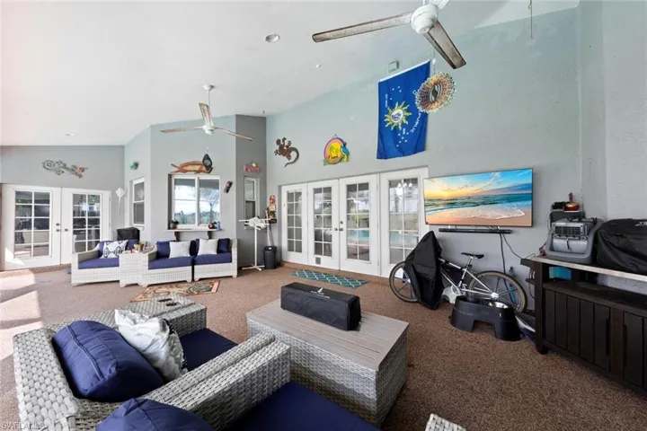 Under truss lanai, french doors, high vaulted ceiling, and ceiling fan
