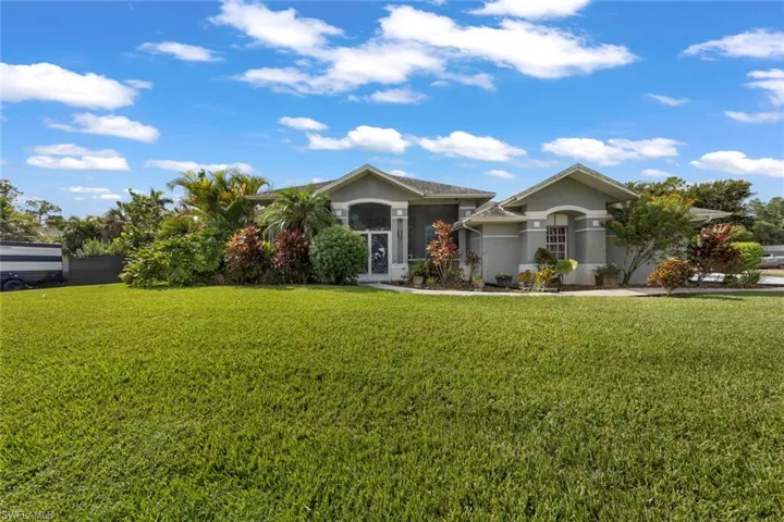 Ranch-style home featuring a front lawn