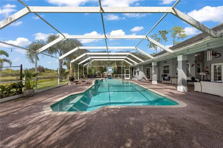 View of swimming pool featuring a lanai and a patio area