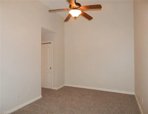 Loft featuring a ceiling fan and baseboards