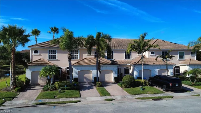 Mediterranean / spanish-style house with a tiled roof, stucco siding, decorative driveway, and a garage