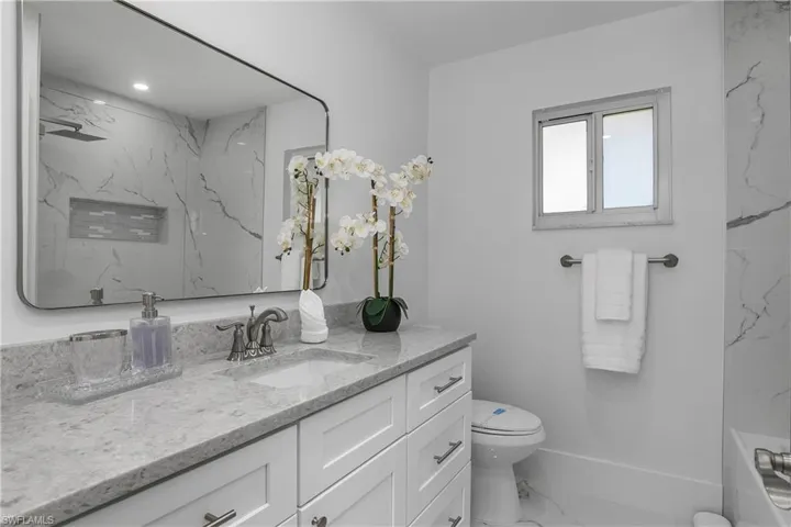Bathroom with vanity and marble finish floors