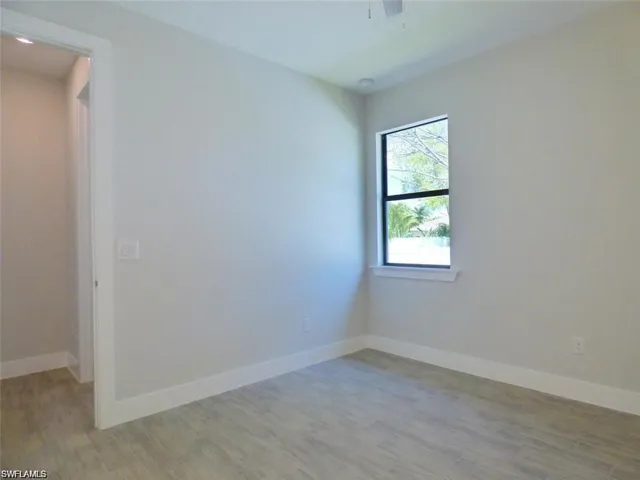 Empty room with hardwood / wood-style flooring