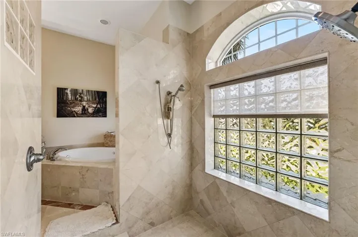 Dual shower heads in the walk thru shower. Glass block windows allow for naturasl light to spill in yet gives you complete privacy!