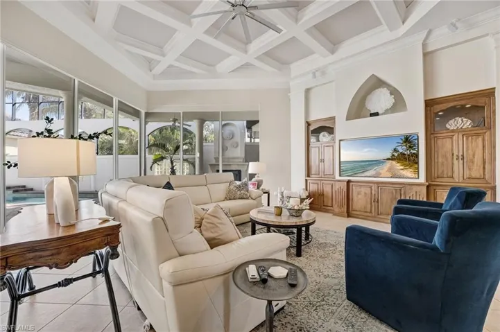 Showcasing exceptional craftsmanship, the main living area boasts custom wood-built walls with elegant insets, providing a refined backdrop for your treasured items.