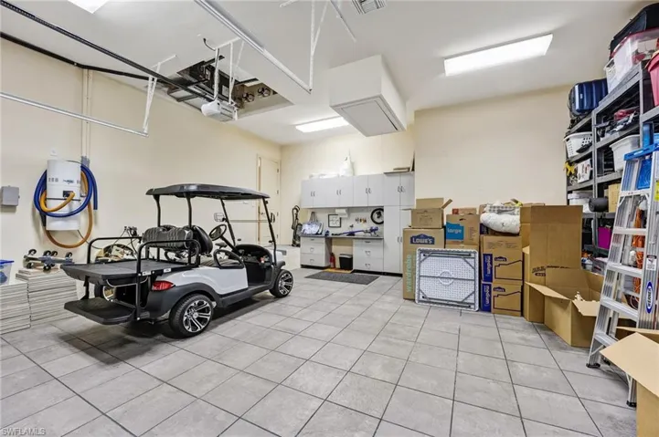 This is one of two oversized two-car garages, featuring abundant lighting, tiled floors, and ample storage throughout.