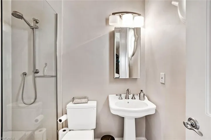 This is a full bathroom with a seamless glass enclosure in the walk in shower.