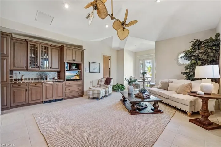 Situated on the second level, this exceptional third bedroom is thoughtfully appointed with a bar sink, icemaker, refrigerator, and abundant custom wood cabinetry—all conveniently within reach. A cozy seating area, elegant Murphy bed, and a full bath complete this beautifully designed and luxurious retreat.