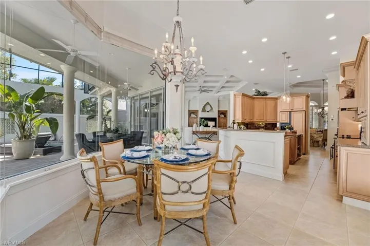 The breakfast nook offers tranquil courtyard views through sleek, seamless framed windows, inviting natural light into every morning.