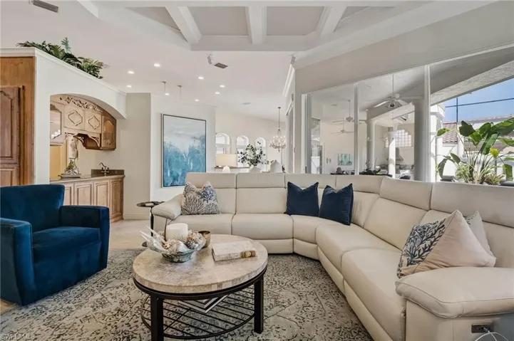 Situated just steps from the main living area, an exquisite wet bar boasts a sleek bar sink, a refrigerator,rich granite countertops, and custom-designed cabinetry, perfect for entertaining in style.