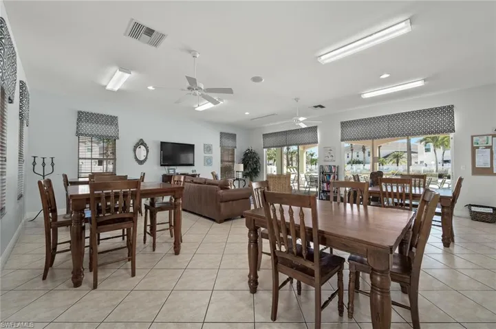 Tiled dining room with ceiling fan