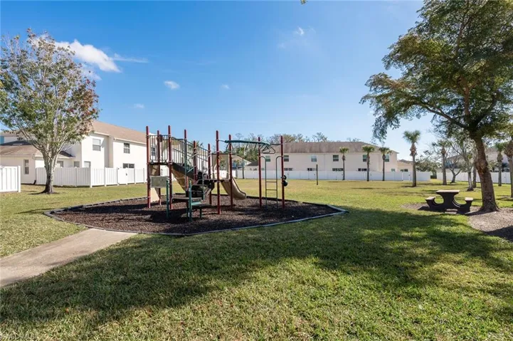 View of play area featuring a lawn