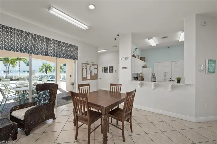 Dining space featuring light tile patterned flooring and vaulted ceiling