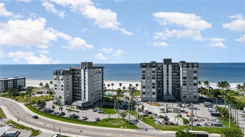 Drone / aerial view of apartment complex and expansive beach