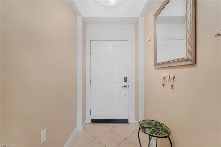 Entryway featuring tile patterned flooring and baseboards