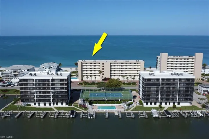 Coastal condominium building featuring multiple levels of private balconies