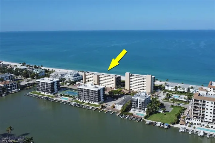 Waterfront condominium complex featuring a beachfront setting, direct Gulf access, boat docks, and on-site tennis courts