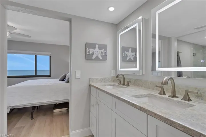 Dual vanity featuring light-toned countertops and undermount sinks