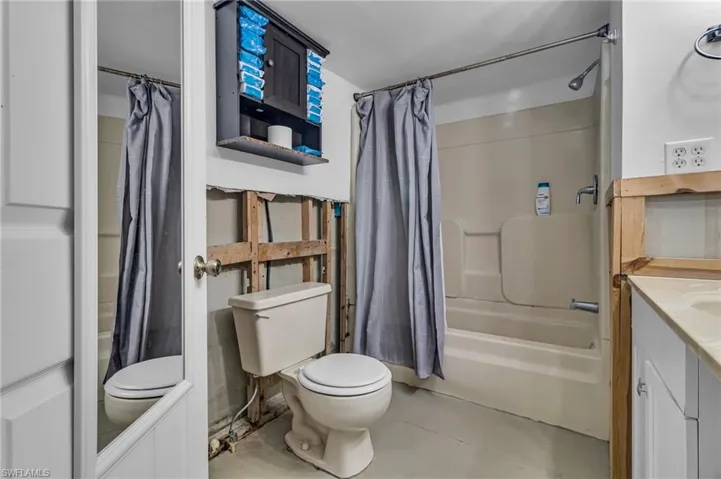Full bath featuring shower / bath combo, vanity, and toilet