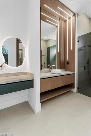 Contemporary bathroom featuring light-toned large format floor tiles