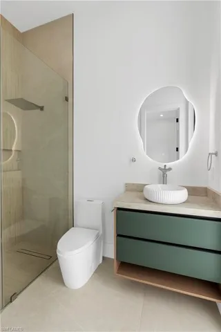Walk-in shower with rain head and glass enclosure