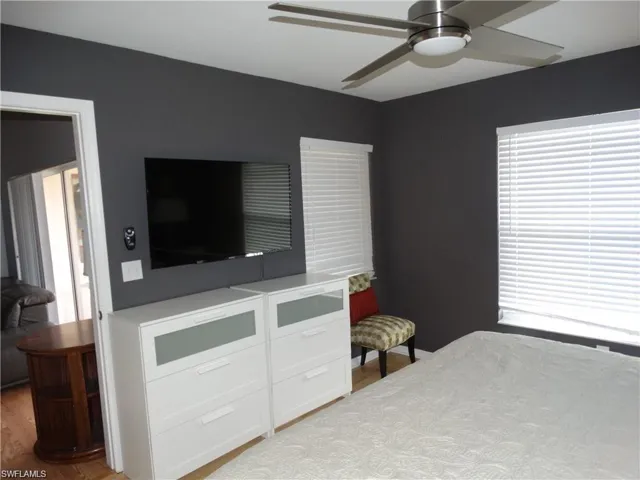 Bedroom with a ceiling fan and light wood-type flooring