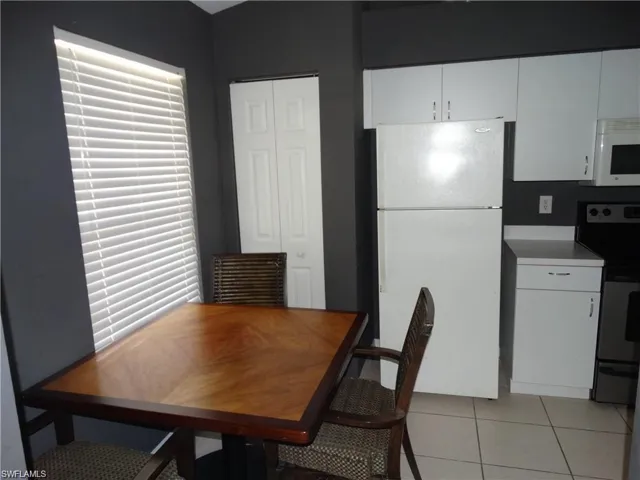 Dining space with light tile patterned floors