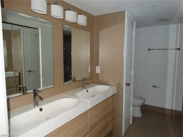 Full bath with double vanity and toilet