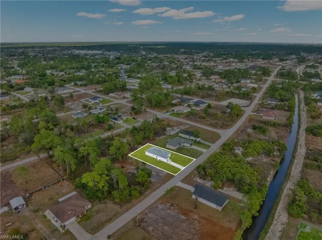 Aerial perspective of suburban area featuring property parcel outlined