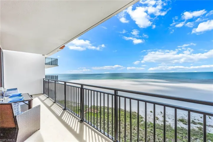 Balcony with view of water and beach