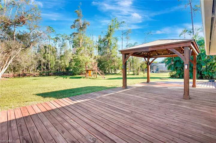 Views of pergola & large yard with lake