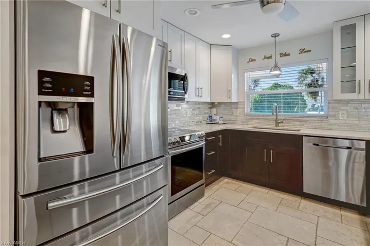 Closer kitchen look with its upgraded kitchen appliances, barnyard sink, and custom cabinets