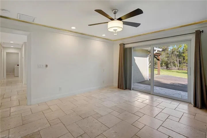Primary suite with view of lanai & backyard