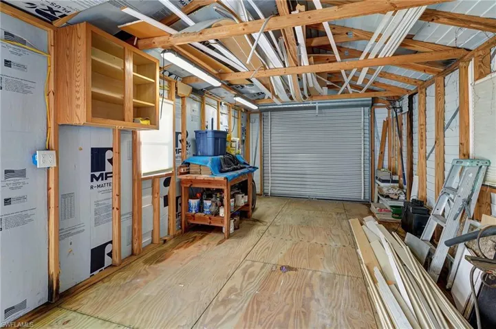 12' x 24' shed/workshop with cabinets, work bench with electric, large accordian entry door, plus side door entrance (not shown)