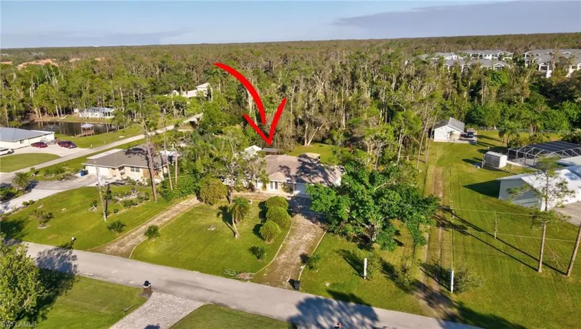 Aerial view looking from across the street plus surrounding homes
