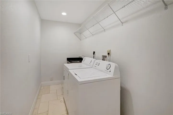 Laundry room with washer, dryer, and sink