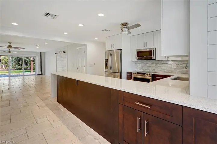 Upon entering the home, great view of kitchen and slider doorwall