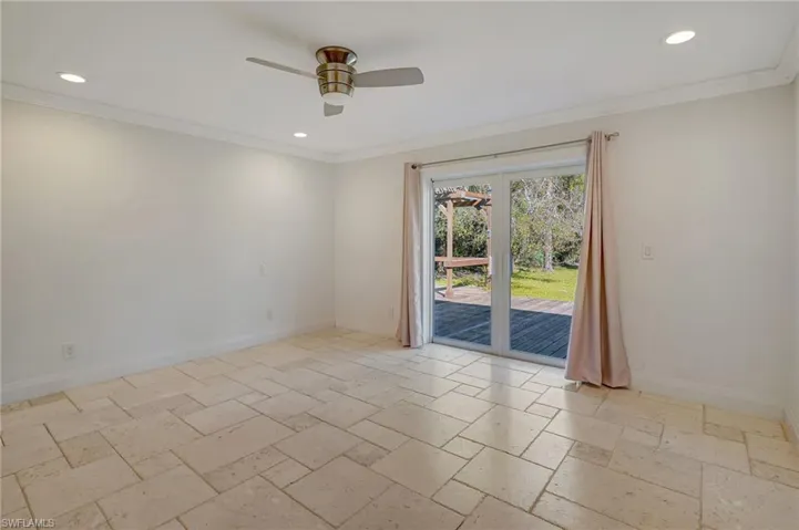 Bedroom with view of lanai/backyard