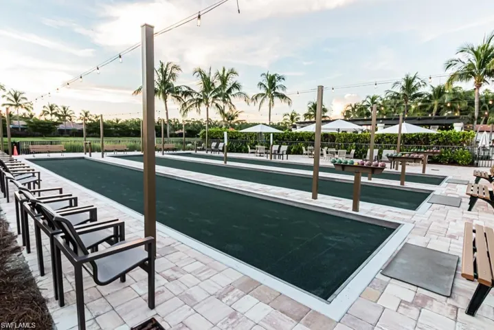 View of property's community with a bocce ball area and a patio