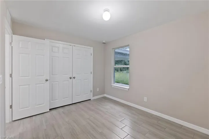Unfurnished bedroom featuring light hardwood / wood-style floors and a closet