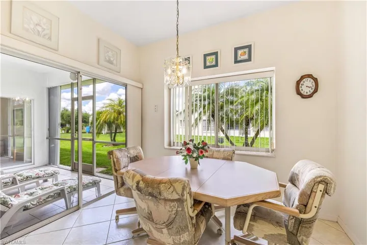 Tiled dining area featuring a chandelier