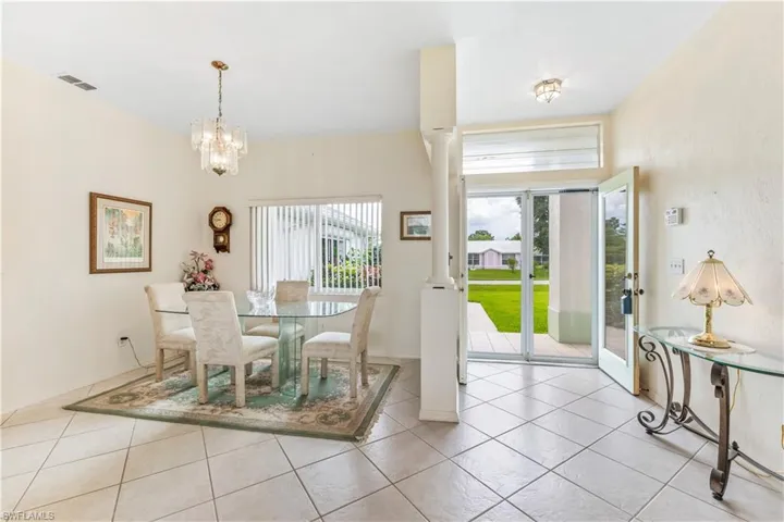 Tiled dining room with a notable chandelier
