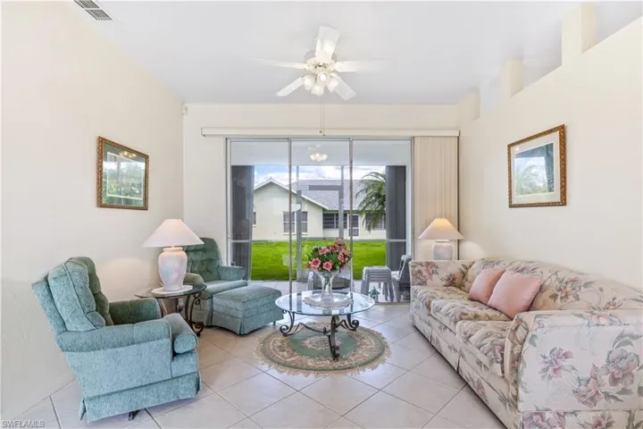 Living room featuring tile floors and ceiling fan