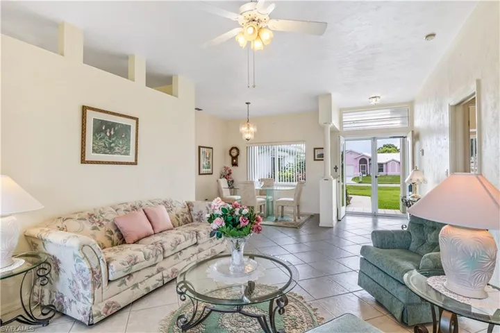 Tiled living room featuring ceiling fan